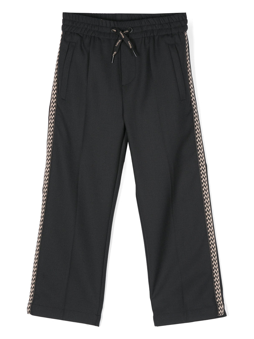 Trousers with braid