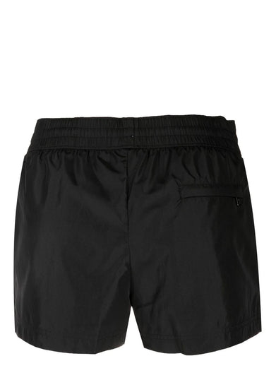 Short swim trunks with branded tag