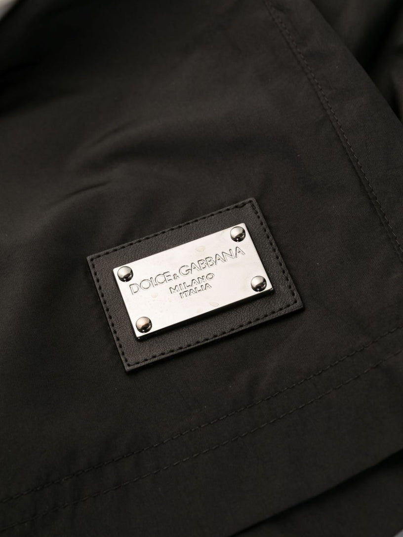 Swim trunks with logo tag